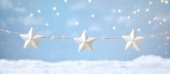 Festive white paper stars strung on a twinkling string against a soft blue sky with gently falling snowflakes creating a winter wonderland scene