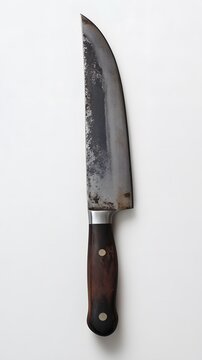 17. A top-down shot of a large kitchen knife with a high-carbon steel blade, set against a white background