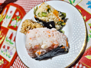 Tuna, Crab, and Vegetable onigiri on a white plate
