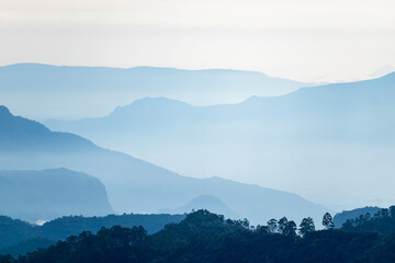 Early morning view of Kodaikanal, showcasing soft blue hues of distant mountains shrouded in mist