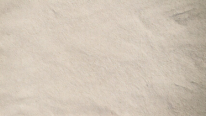 Naklejka premium Close-up of pale beige beach sand texture background
