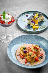 A trio of decadent desserts, including cheesecake, panna cotta, and syrniki, each with its own unique flavor and texture.