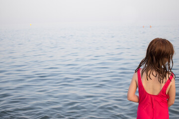 Girl from behind. Summer beach travel vacation concept. holiday with kids. Horizontal. Copy space. Mediterranean