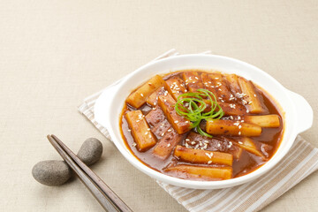 Tteokbokki or Topokki, stir fried rice cake stick, popular Korean street food with spicy gochujang sauce and sesame seed. 

