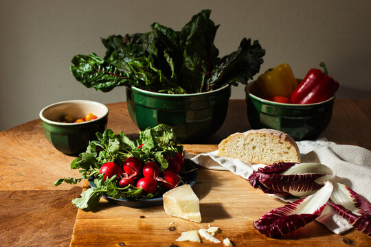 Cheese, vegetables, bread on a table