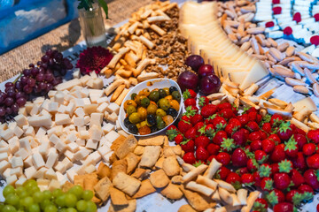 Wedding catering showing strawberries, cheese, olives, grapes, nuts, and breadsticks