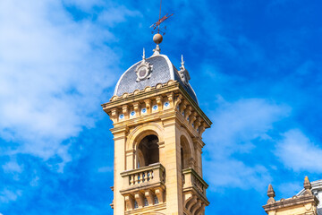 Historic clock tower against vibrant blue sky San Sebastian City Hall