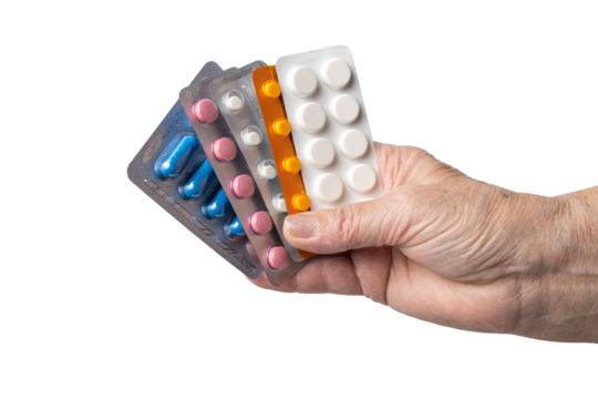 Senior female hand holding various blister packs of prescription medication, antibiotic pills, painkiller capsules, isolated on a transparent background. Healthcare, elderly care, medical treatment