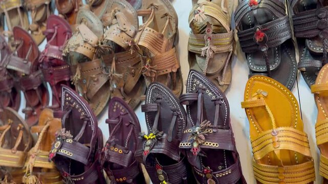 Panning shot of traditional Indian footwear known as Kolhapuri chappal