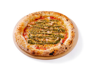 Unique pesto pizza topped with tender chicken on a wooden serving tray in a casual dining setting