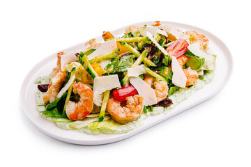 Refreshing shrimp salad topped with fresh vegetables and shaved cheese served on a white plate
