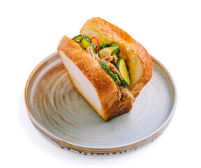 Delicious sandwich filled with tender meat and fresh vegetables on rustic plate