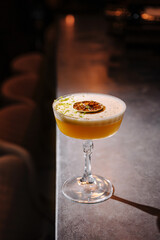 Handcrafted cocktail garnished with lime and citrus served in an elegant glass on a polished bar counter