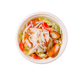 Fresh salad with crispy chicken, lettuce, tomatoes, and cheese prepared in a takeout bowl for a quick meal option