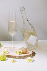 Elegant sparkling beverage served on a wooden slice with floral accents in a serene setting