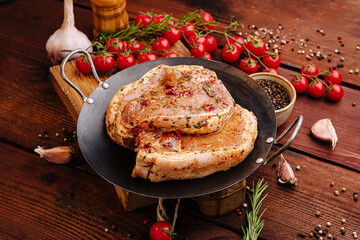 Savory marinated steak on a grill plate surrounded by fresh herbs and vegetables