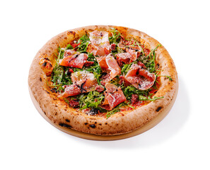Delicious handmade pizza topped with fresh greens, prosciutto, and cheese served on a rustic wooden platter