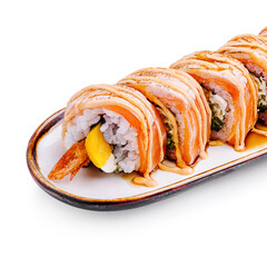 Delicious sushi roll with salmon, shrimp, and avocado served on a white plate with drizzled sauce