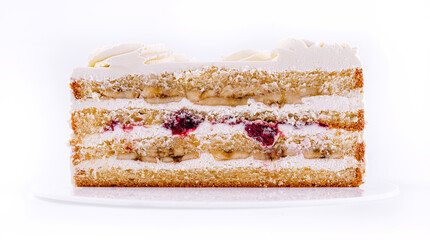 Delicious layered cake with cream, fruit filling, and decorative icing showcased on a white plate