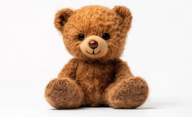 Obraz premium A cute brown teddy bear sits against a white background, showcasing its plush texture and adorable design. The simple setting emphasizes its charm, making it perfect for gifts or decorations.