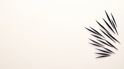 Arrangement of black toothpicks scattered artistically on a light background for creative use