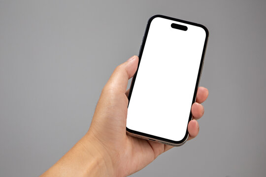 Hand holding the black smartphone with blank screen and modern frameless design isolated n white background.
