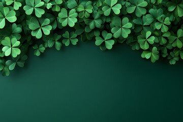St. Patrick's Day background with shamrock leaves on a dark green color, with copy space for text, in a top-view composition. St.