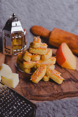 Kastengel or Dutch version of kaasstengels is Indonesian cheese stick or cheese cookies. its popular cookies that Indonesian household will have during a festive celebration. selected focus, wooden