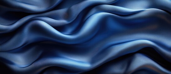 Fototapeta premium Elegant navy blue silk satin fabric background with soft wavy folds ideal for Christmas, birthday, anniversary, or award design templates.