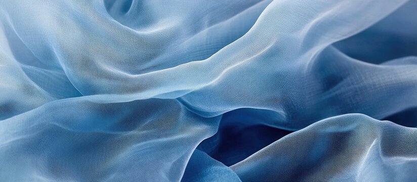 Delicate blue indigo batiste fabric texture with soft flowing layers and subtle color variations for elegant design backgrounds