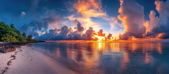 Obraz premium Stunning Tropical Sunset Over Serene Ocean with Vibrant Clouds and Reflection Ideal for Nature Landscape Promotions and Travel Themes