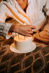 Celebrating a special moment with a birthday cake and candles in a cozy indoor setting during evening time