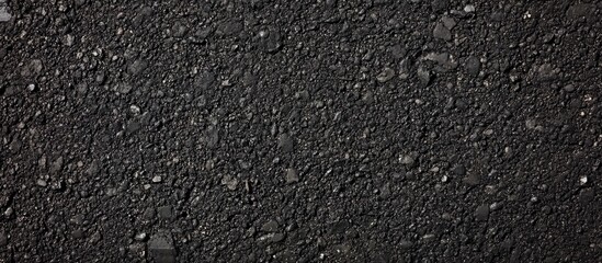 High-resolution black asphalt texture ideal for backgrounds and road surface designs with visible pavement details and smooth finish.