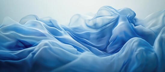 Obraz premium Blue abstract fabric background with smooth flowing waves and gentle gradients for elegant design and artistic compositions