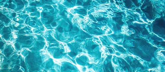 Obraz premium Aerial view of shimmering blue liquid surface patterns creating an abstract and tranquil underwater scene.