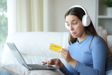 Perplexed woman buying media online