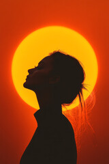 A warm, backlit shot of a womanâ€™s silhouette framed by an intense sun halo, complemented by