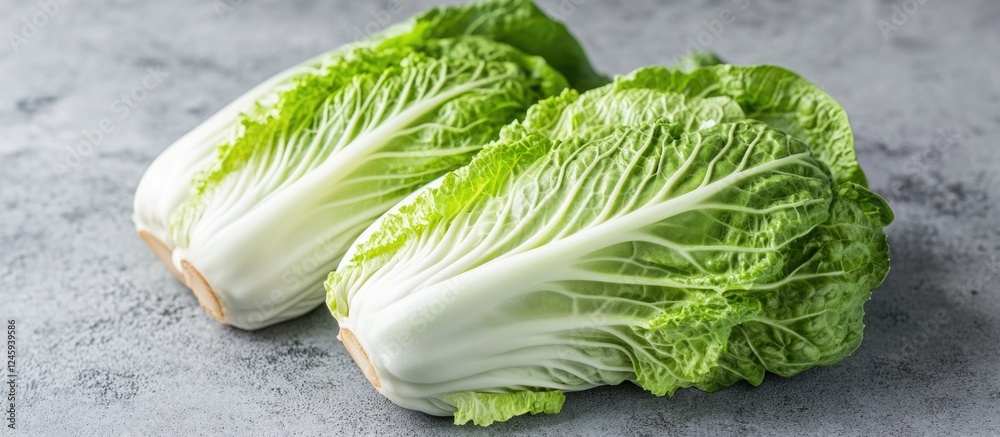Poster fresh heads of napa cabbage showcasing vibrant green leaves and crisp texture on a rustic gray backg