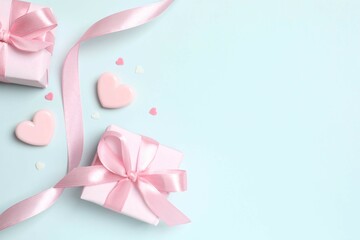 Beautiful composition with gift boxes and pink hearts on color background
