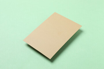 Craft paper card on green background