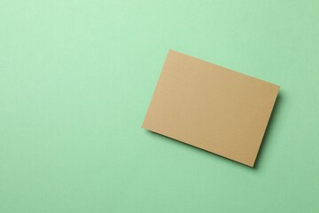 Craft paper card on green background