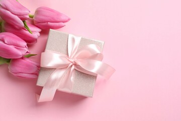 Beautiful fresh tulips with gift box on color background