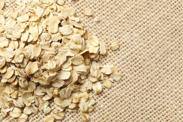 Composition with oatmeal flakes on gray background. Cooking breakfast