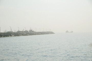 harbor mole and ship in the fog