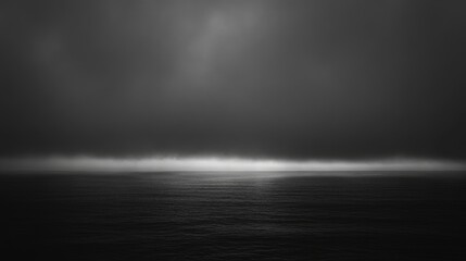 Moody seascape featuring dark clouds and an ethereal horizon creating a dramatic backdrop with ample empty space for text overlay