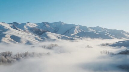 Majestic snow-covered mountains with ethereal fog rolling through the valleys below