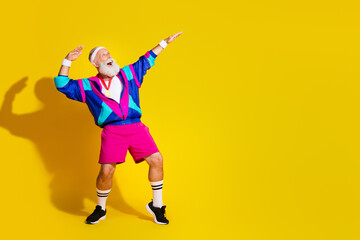 Full size photo poster of handsome granddad sportsman golden medal dance wear trendy vintage sportswear isolated on yellow color background