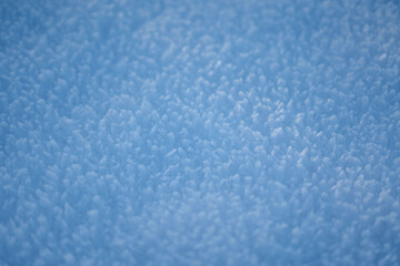 This is a detailed close up of a snowcovered pile against a blue background