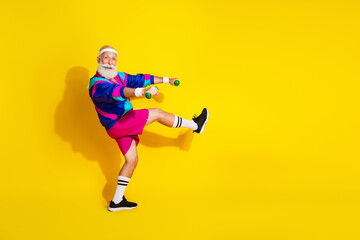 Full size photo poster of handsome granddad sportsman lift dumbbells step wear vintage sportswear isolated on yellow color background