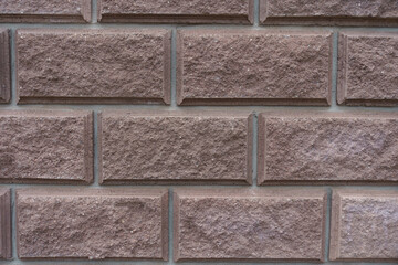 Close view of brownish pink split face brickwork with stretcher bond pattern
